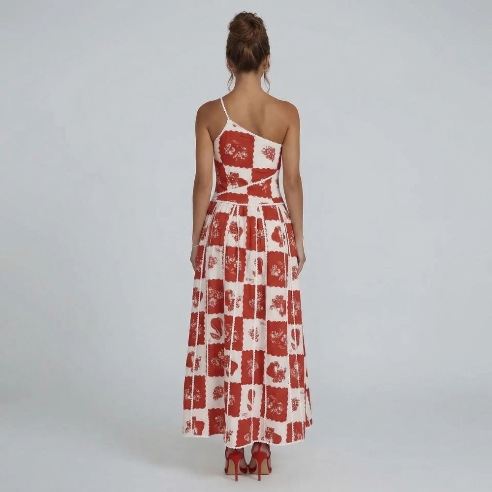Red and white floral patchwork maxi dress with scalloped trim — back view highlighting asymmetric neckline.