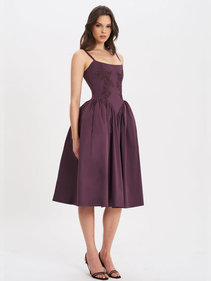 Purple lace midi dress with delicate straps, styled with black heels — side view.
