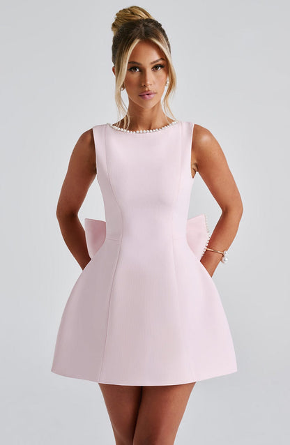 Pink mini dress — front view featuring bateau neckline and structured fit-and-flare silhouette.