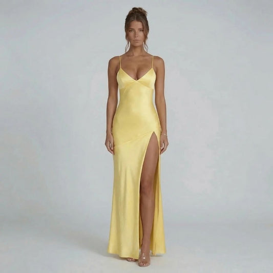 Yellow lace-up maxi dress with thigh slit — front view showcasing the fitted silhouette and bold neckline.