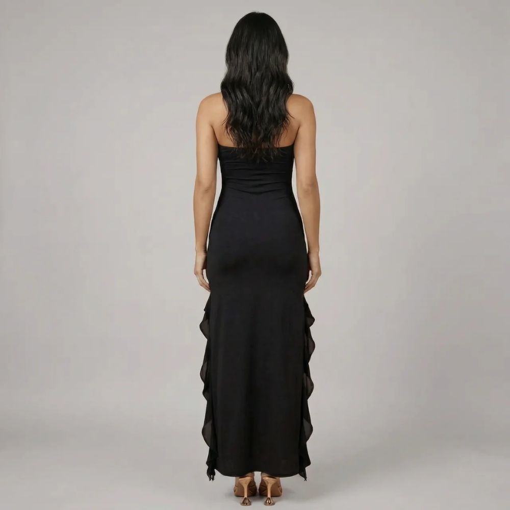 Back view of black ruffle maxi dress showcasing sleek, body-skimming fit