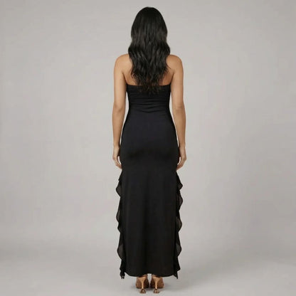 Back view of black ruffle maxi dress showcasing sleek, body-skimming fit