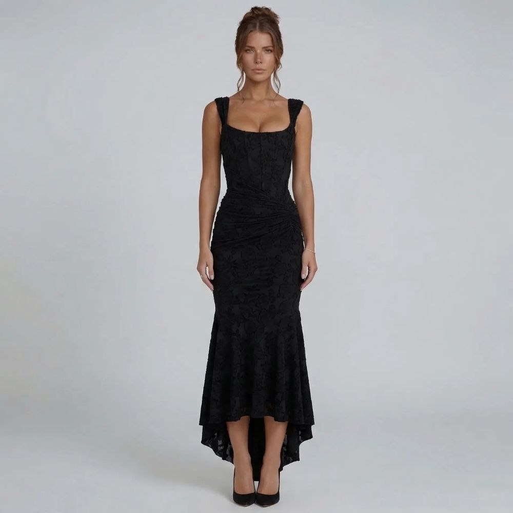 Black lace maxi dress with wide straps and high-low hem — front view styled with black pumps.
