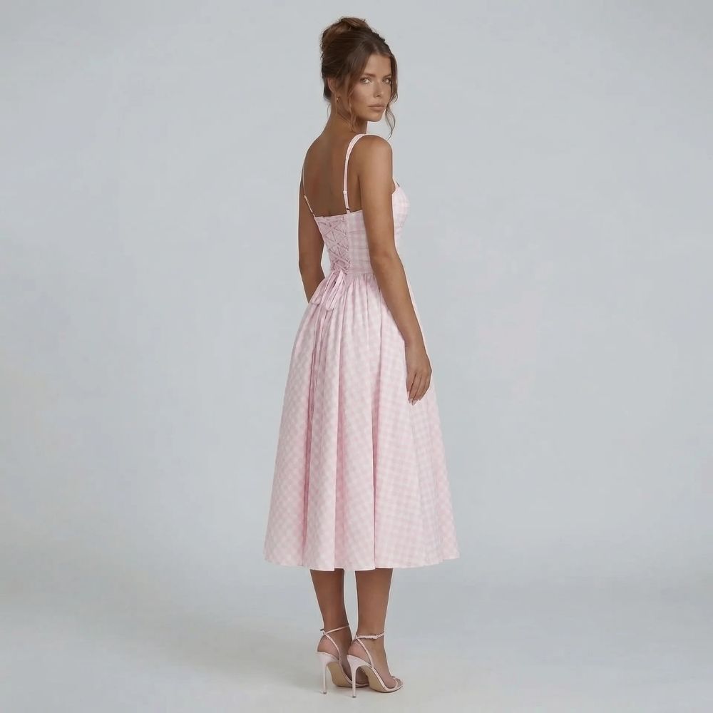 Pink gingham corset midi dress styled with heels — side angle view