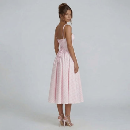 Pink gingham corset midi dress styled with heels — side angle view