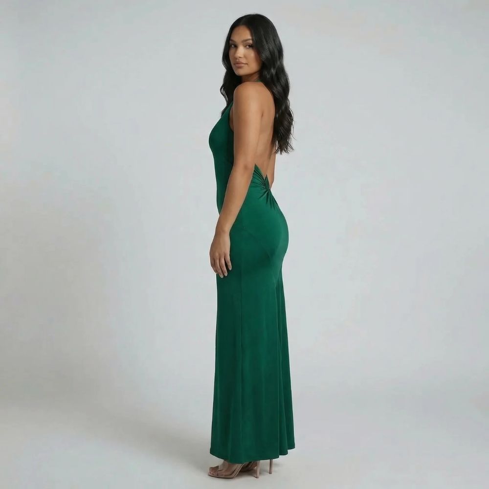 Emerald green halter ruched maxi dress — side view showcasing open back detail and column fit.