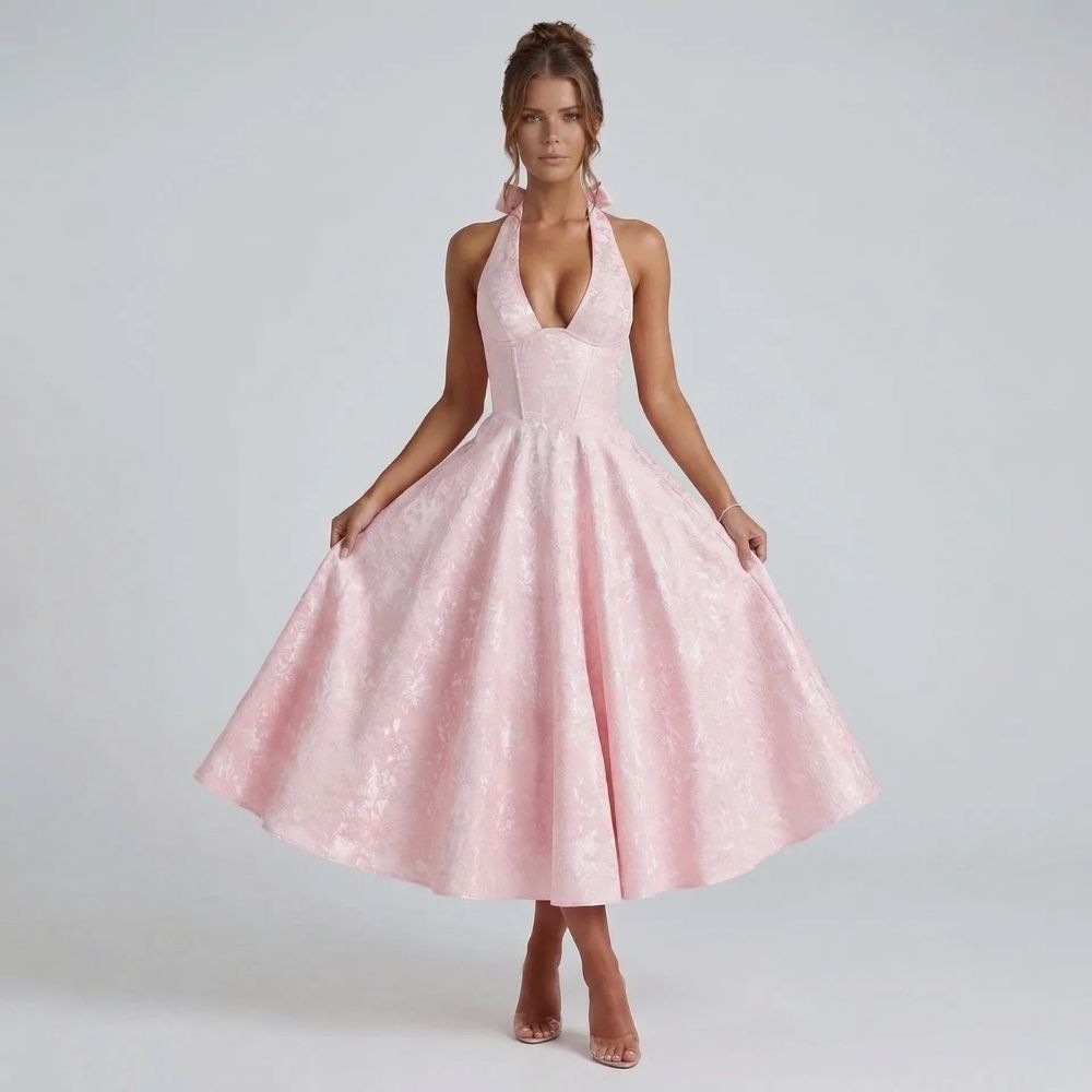 Pink jacquard halter midi dress with bow-tied back — front view showing the deep V neckline and flattering A-line skirt.