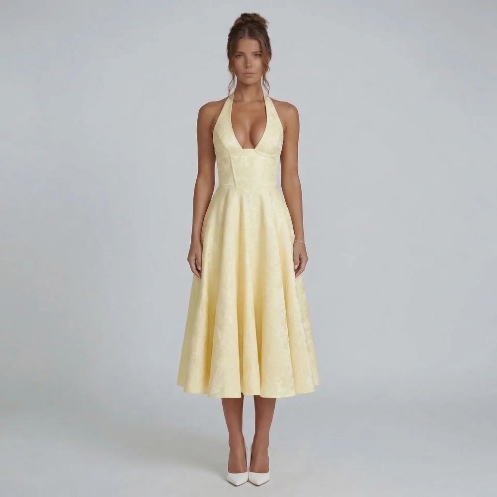 Yellow jacquard halter midi dress with bow-tied back — front view showcasing the fitted bodice and flowing skirt.