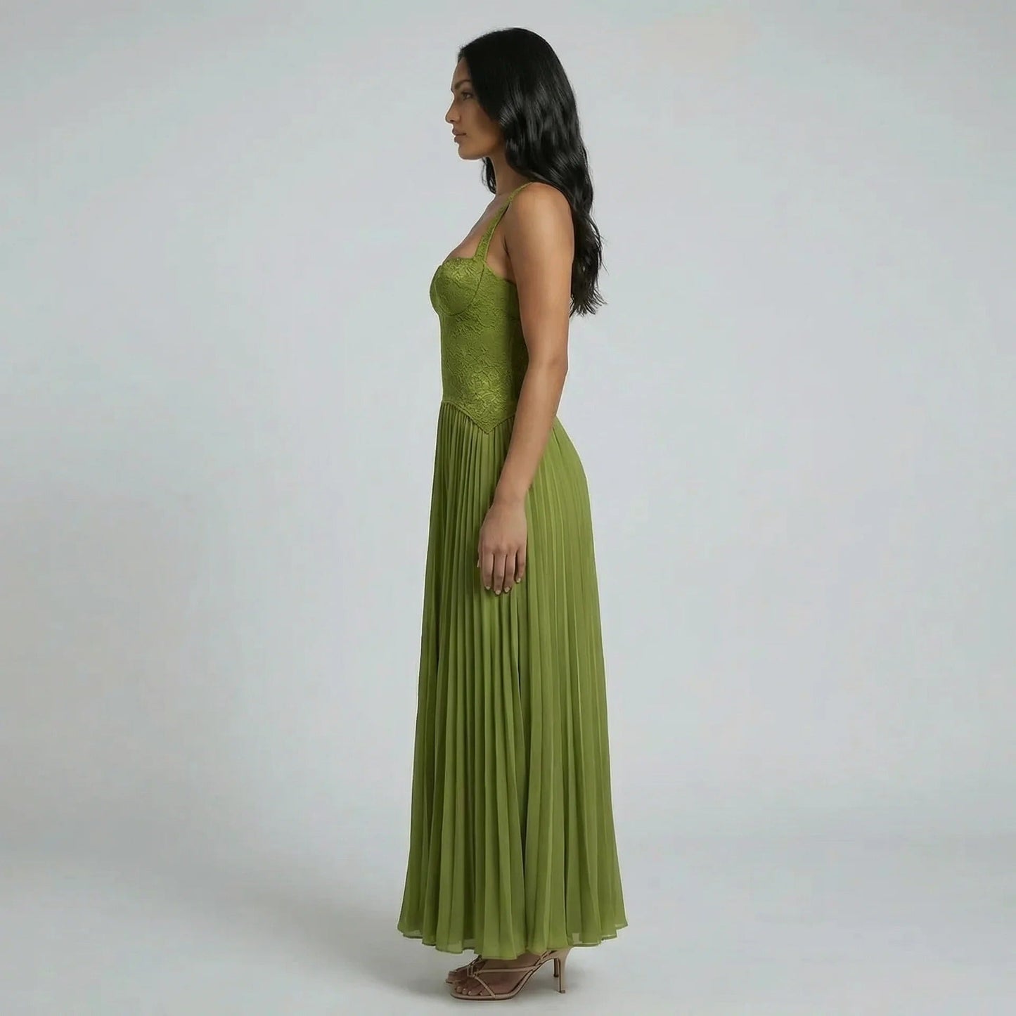 Side view of the olive green lace corset maxi dress with pleated flowing skirt.