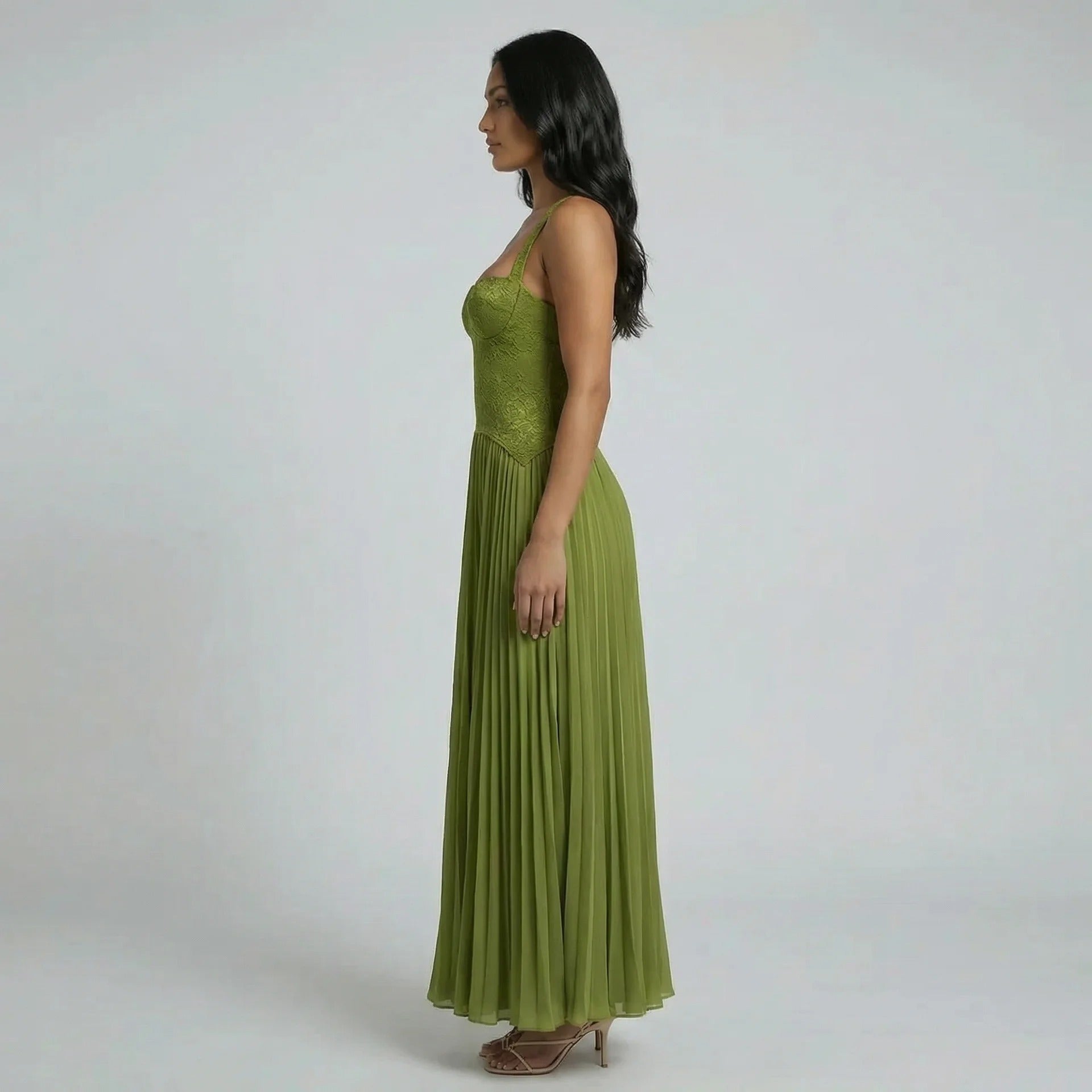 Side view of the olive green lace corset maxi dress with pleated flowing skirt.