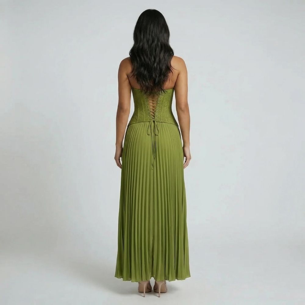 Back view showing lace-up detail and sweeping pleated skirt in olive green.