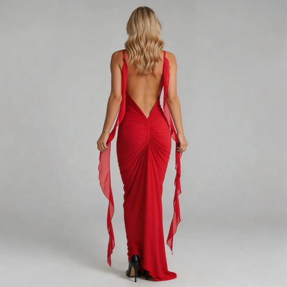 Red bodycon maxi dress with open back and cascading chiffon panels — model backward angle.