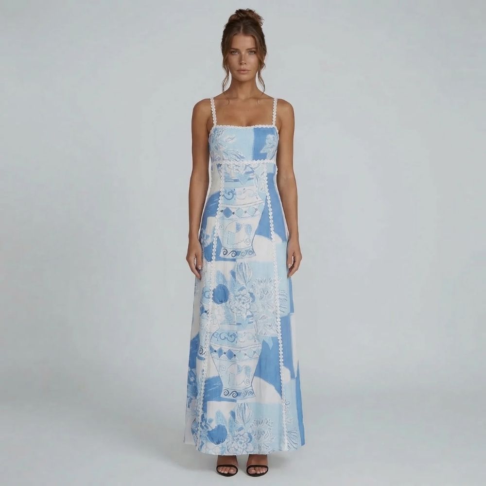 Blue and white patchwork print maxi dress with crochet trim — front view showing flowy silhouette and straight neckline.