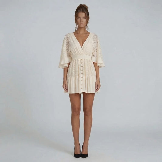 Ivory lace mini dress with flutter sleeves and button-down front — front view showing deep V-neckline and smocked waist.