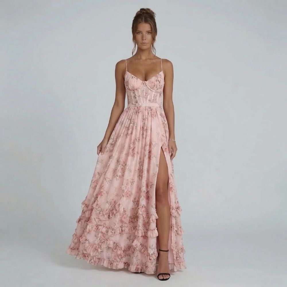 Pink floral corset maxi dress with tiered ruffles — side slit highlighting graceful movement
