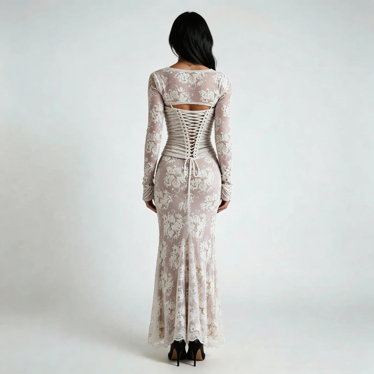 White lace maxi dress with corset lace-up back and floral details — back view highlighting the design.