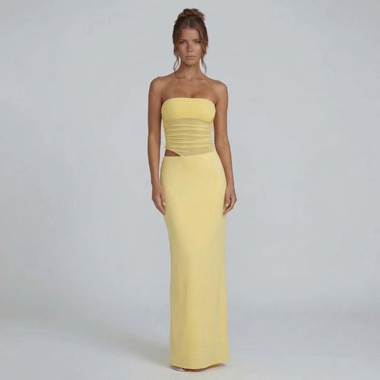 Yellow strapless ruched maxi dress with side cutout — front view showing fitted bodice and flowing skirt.