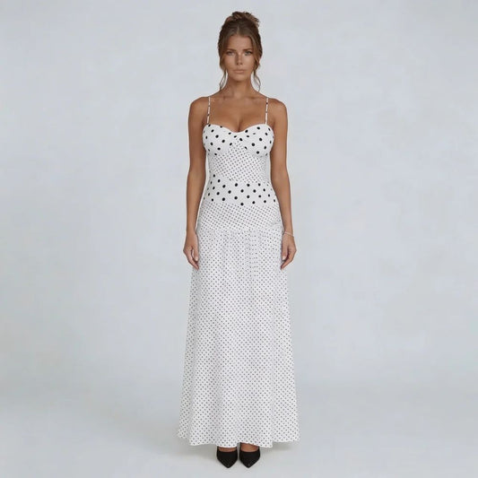 White polka dot maxi dress with sweetheart neckline and halter tie — front view showcasing flowing silhouette.