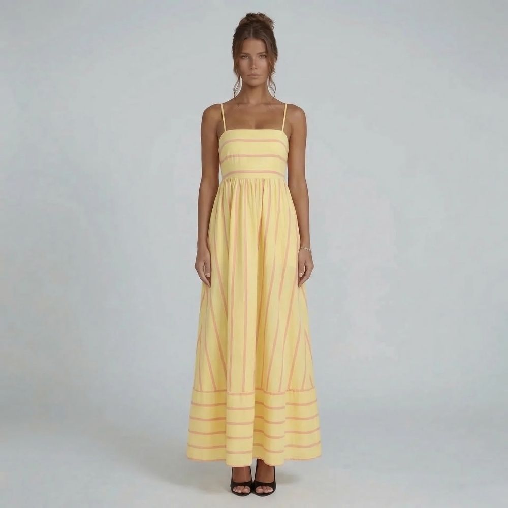 Yellow striped maxi dress with straight neckline and spaghetti straps — full front view styled with black heels.