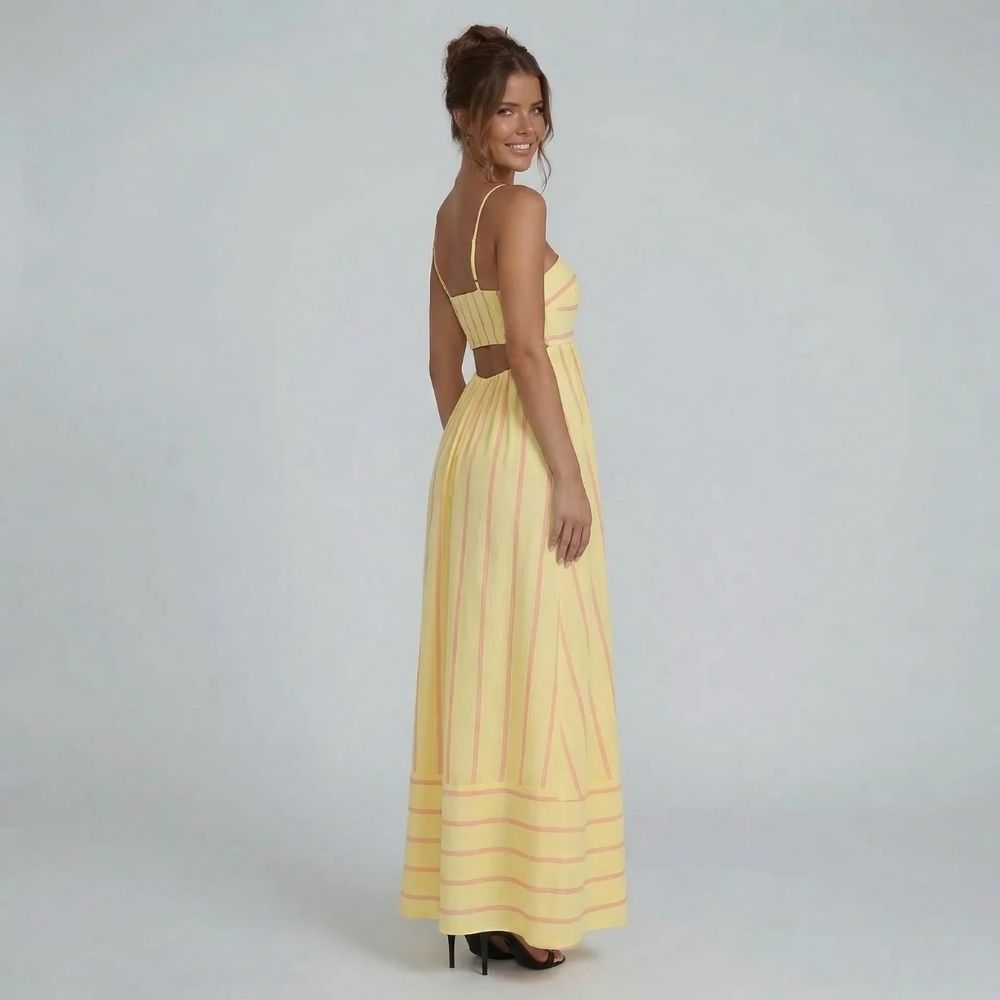 Yellow striped maxi dress with smocked back — side view highlighting flowing silhouette and light summer fabric.