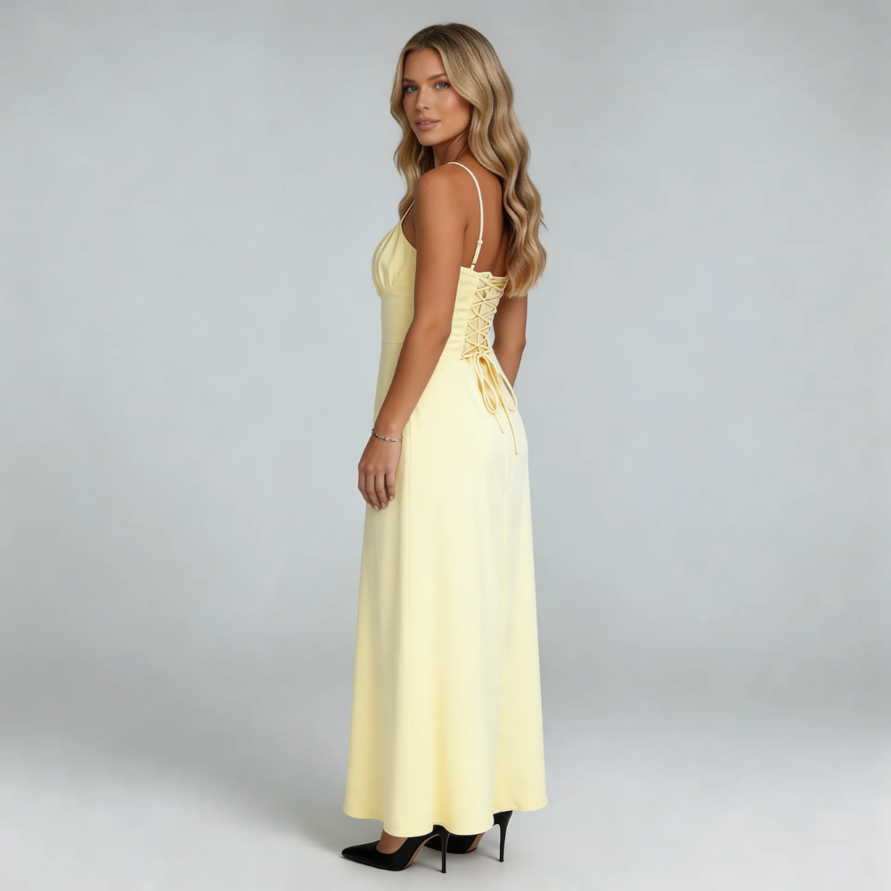 Cream lace-up maxi dress — side view highlighting corset-style back and sweeping skirt.