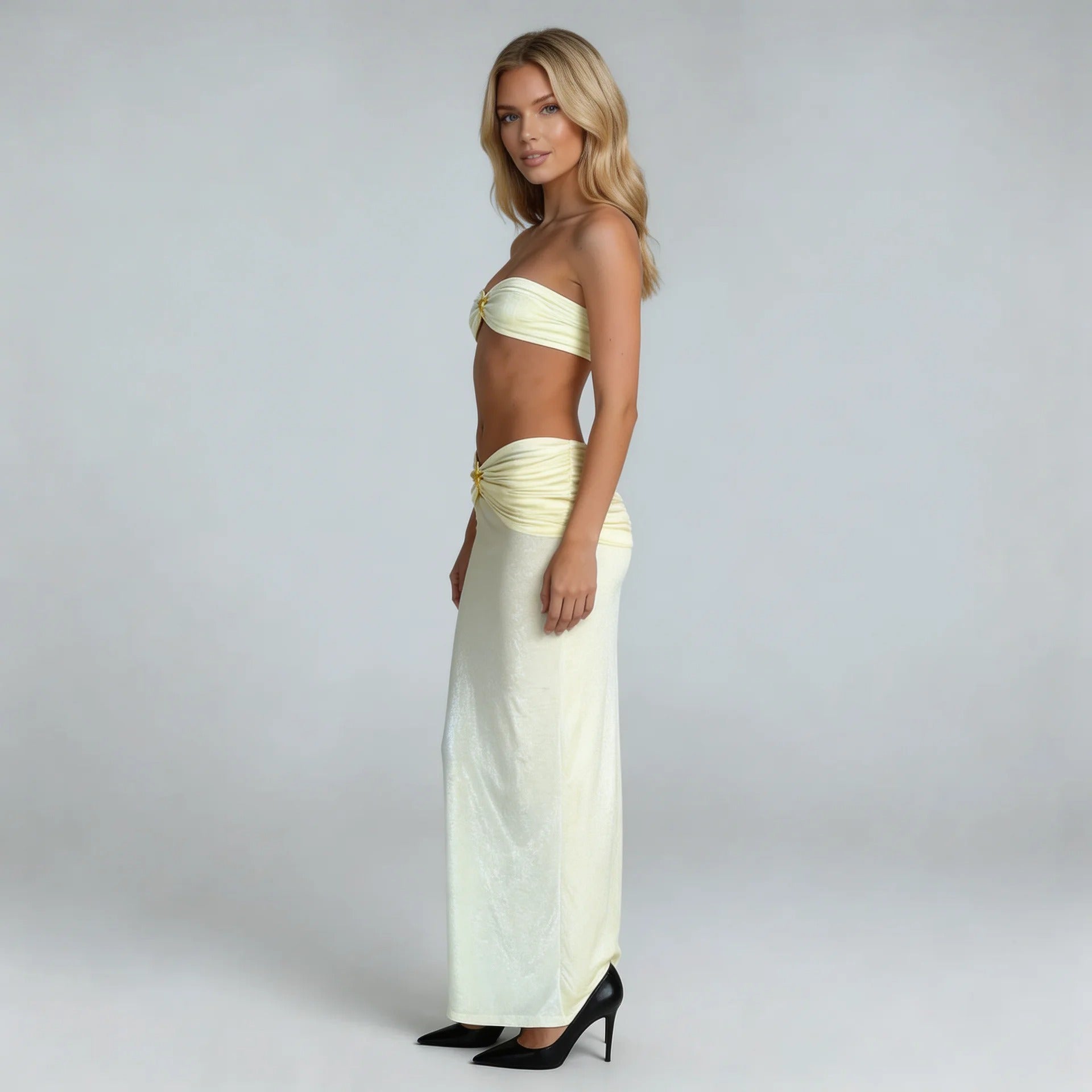 Cream ruched three-piece maxi set with starfish hardware — side profile showing twist bandeau top and flowy skirt.