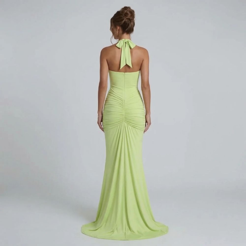 Sage halter maxi dress — back view featuring bow tie detail and sculpted ruching at the waist.