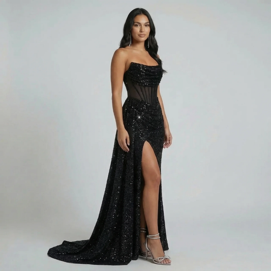 Black sequin maxi dress with bandeau neckline and corset waist—front view showing thigh-high slit.
