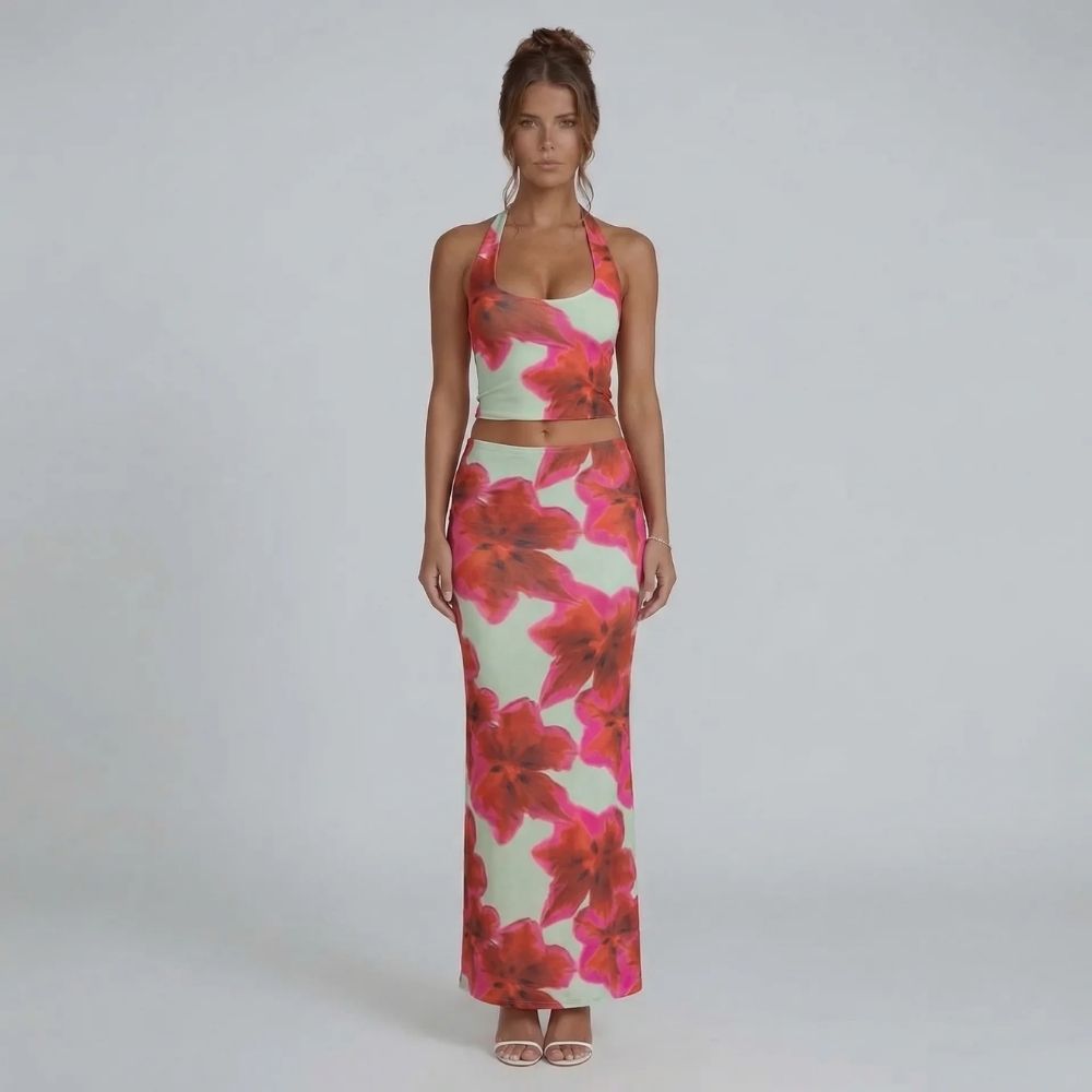 Pink floral halter crop top and matching maxi skirt — front view showing bold print and flowing silhouette.