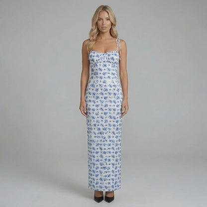 Blue floral maxi dress with corset-seamed bodice and tie straps — front view showing neckline and sweeping skirt.