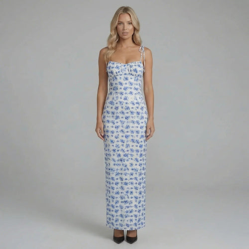 Blue floral maxi dress with corset-seamed bodice and tie straps — front view showing neckline and sweeping skirt.
