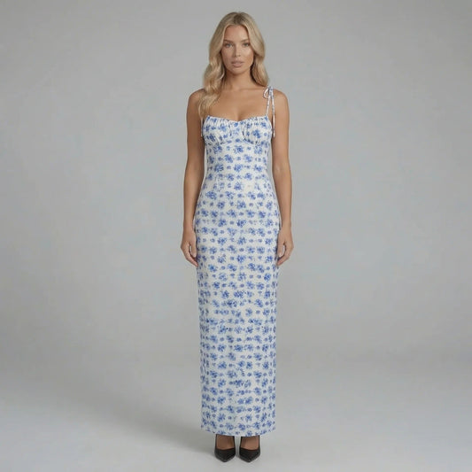 Blue floral maxi dress with corset-seamed bodice and tie straps — front view showing neckline and sweeping skirt.