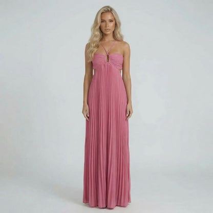 Pink pleated maxi dress with ruched bodice and halter straps, front view.