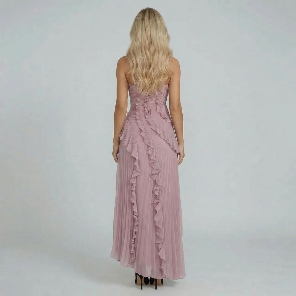 Back view of pink halter maxi dress with ruffle and tie detail — showcasing adjustable straps and texture.