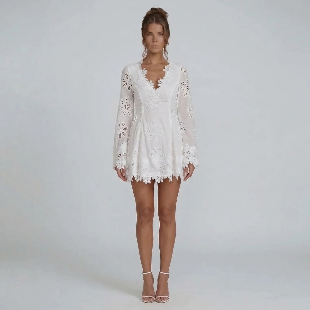 White lace mini dress with bell sleeves and V-neckline — front view showing embroidery details.
