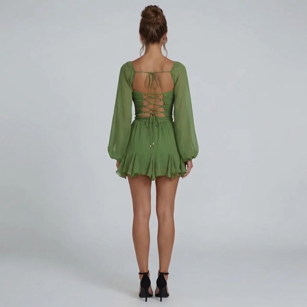 Green chiffon mini dress with corset lace-up back and long slit sleeves — back view.
