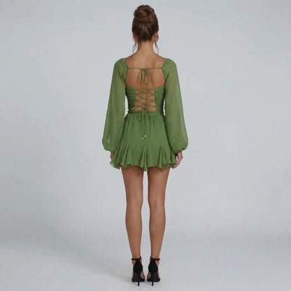Green chiffon mini dress with corset lace-up back and long slit sleeves — back view.