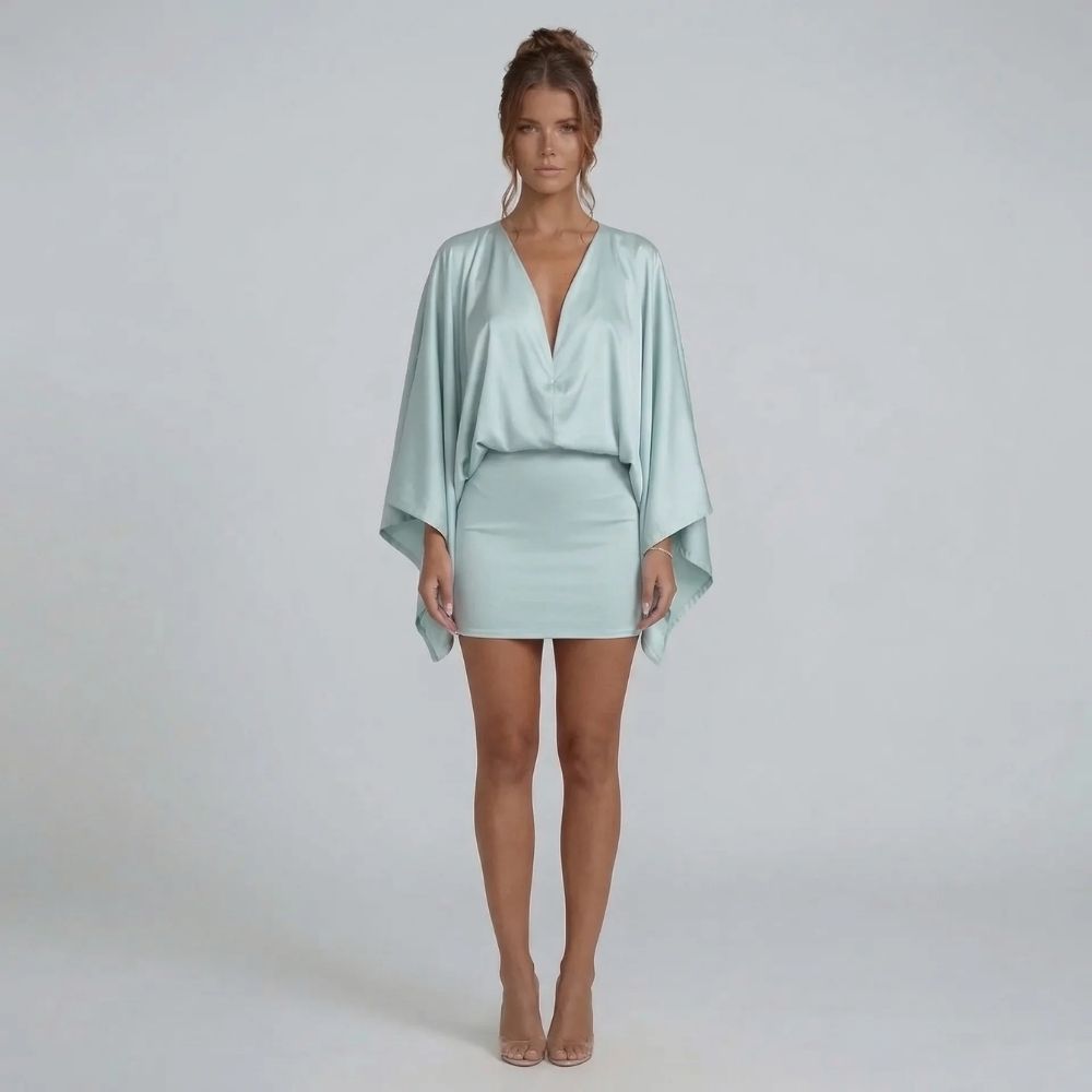 Blue cape-style mini dress with batwing sleeves and curve-skimming skirt — front perspective highlighting details.