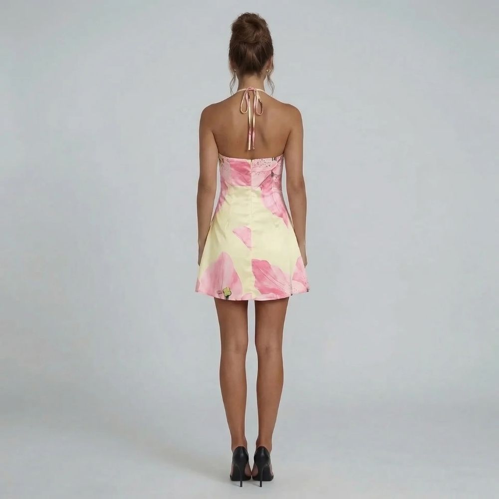 Pink floral halter mini dress — back view showing open-back tie and flowy design.