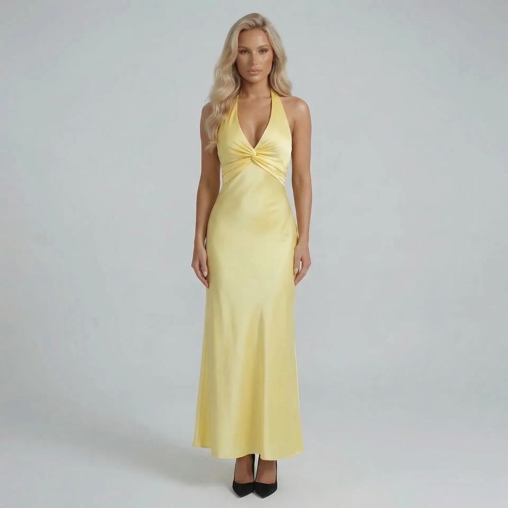 Yellow twist-bust maxi dress with bow-tied open back — front view showcasing elegant silhouette.