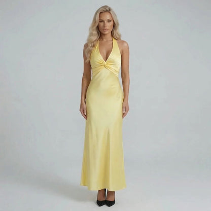 Yellow twist-bust maxi dress with bow-tied open back — front view showcasing elegant silhouette.