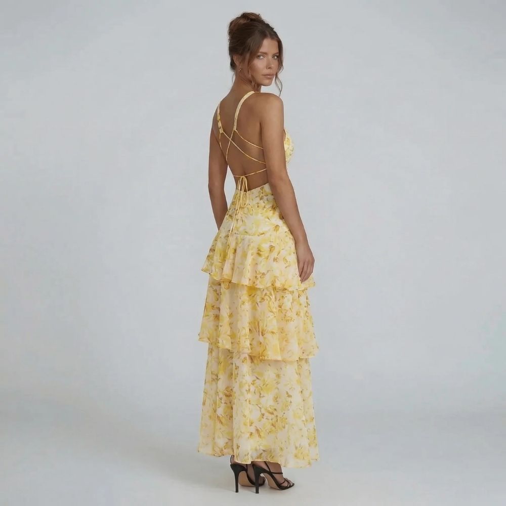 Yellow floral tiered maxi dress with adjustable lace-up back — back angle.