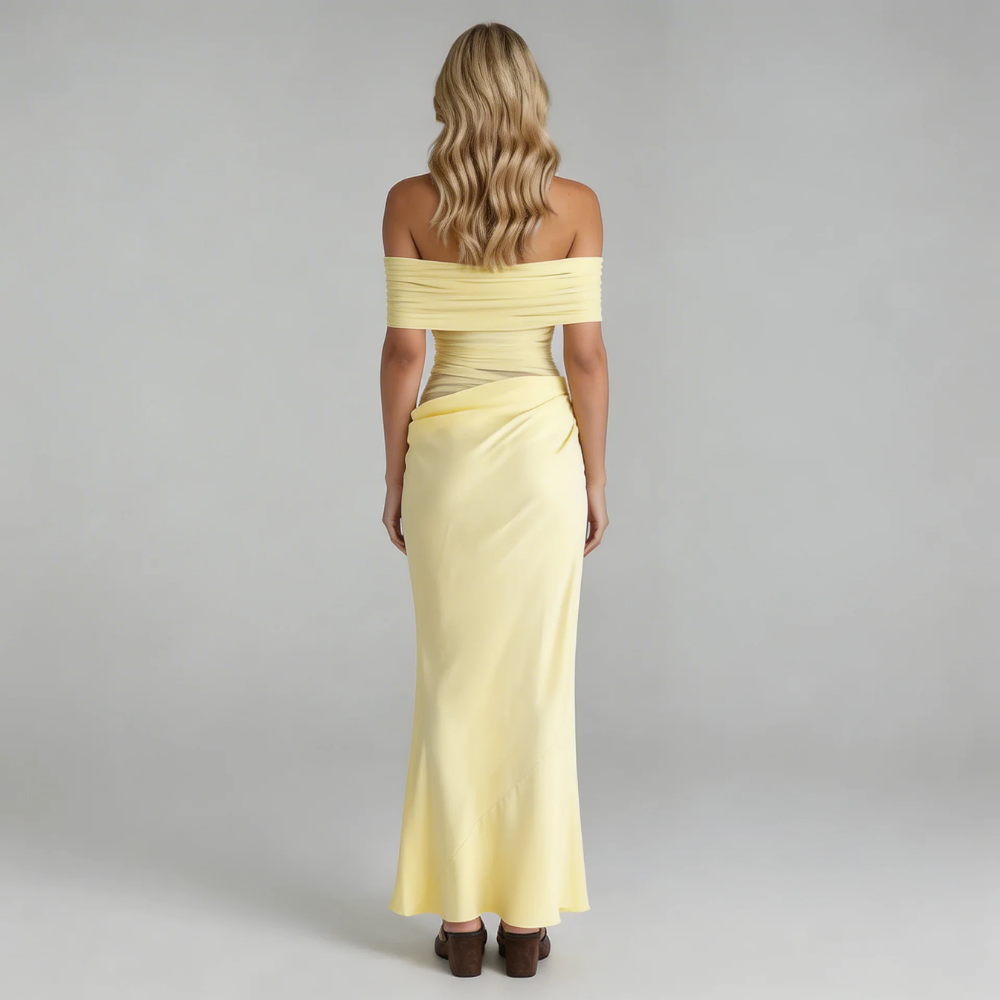 Yellow off-shoulder mesh maxi dress with asymmetric draping — back view emphasizing mesh overlay and clean finish.