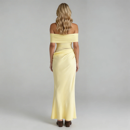 Yellow off-shoulder mesh maxi dress with asymmetric draping — back view emphasizing mesh overlay and clean finish.