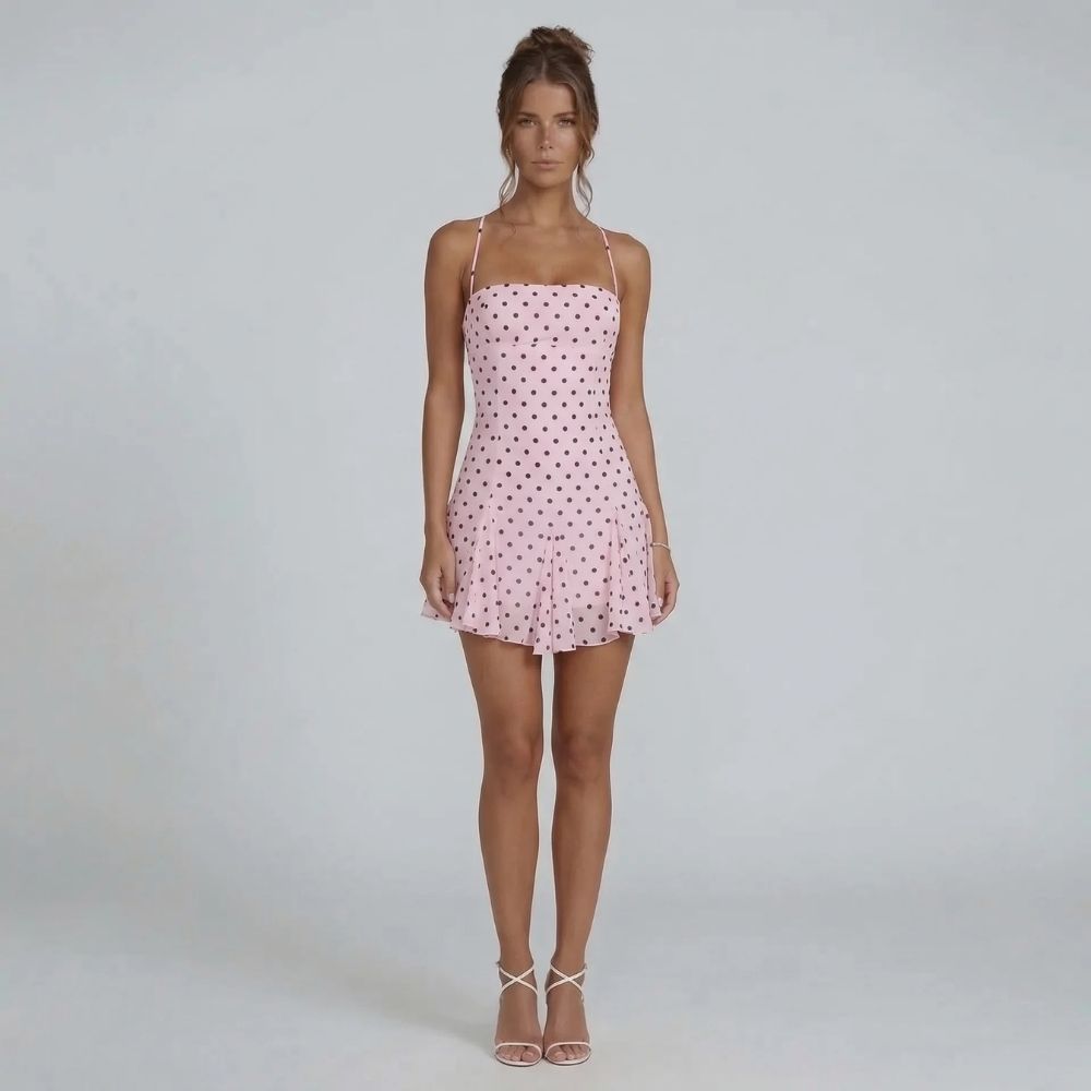 Pink polka-dot halter mini dress — front view with swishy skirt and charming print.