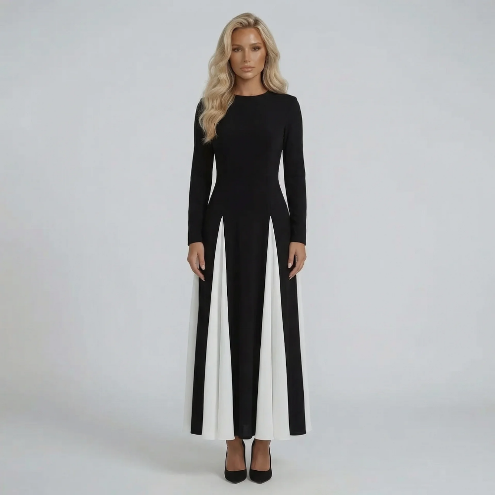 Black and ivory long-sleeve maxi dress — front view showcasing sculpted silhouette and contrast flow.