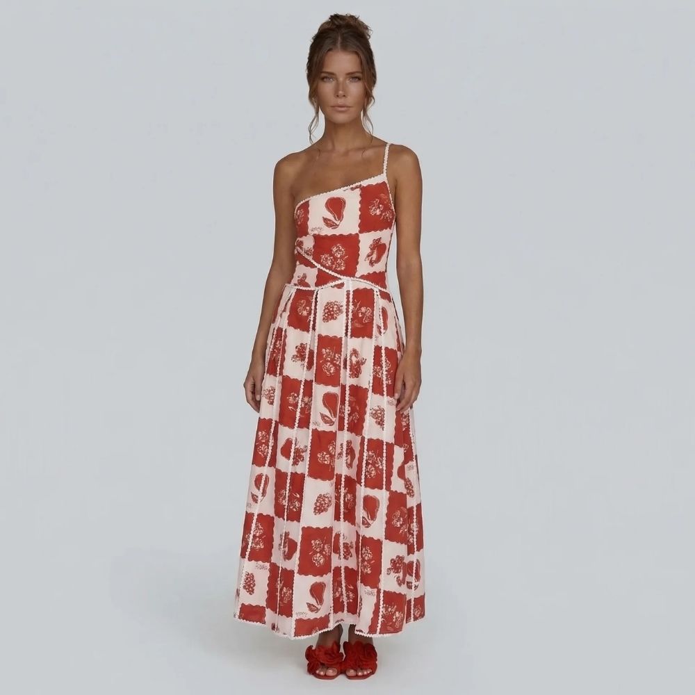 Red and white floral patchwork maxi dress with one-shoulder neckline — front view showing flowing skirt.