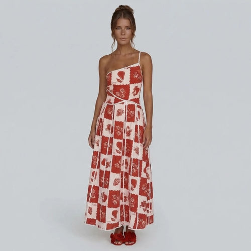 Red and white floral patchwork maxi dress with one-shoulder neckline — front view showing flowing skirt.
