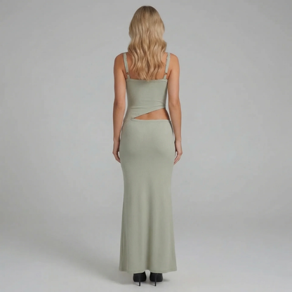 Sage cutout maxi dress featuring cutout waist — back angled view with flowing silhouette.