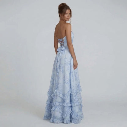 Light blue maxi dress with lace-up open back and cascading hem, back view.